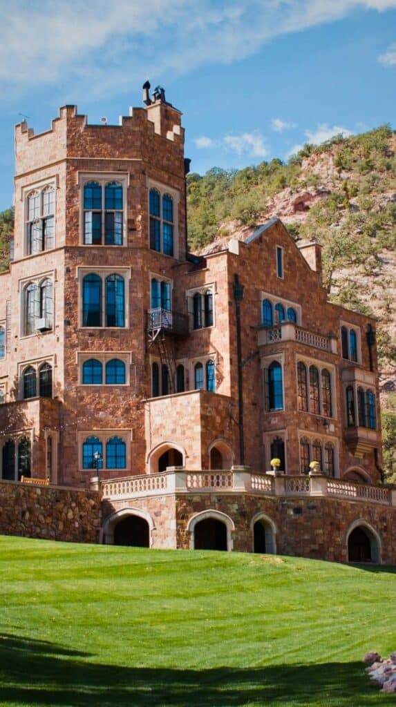 Stone facade of Glen Eyrie Castle, one of the historic hotels Colorado Springs is proud of.
