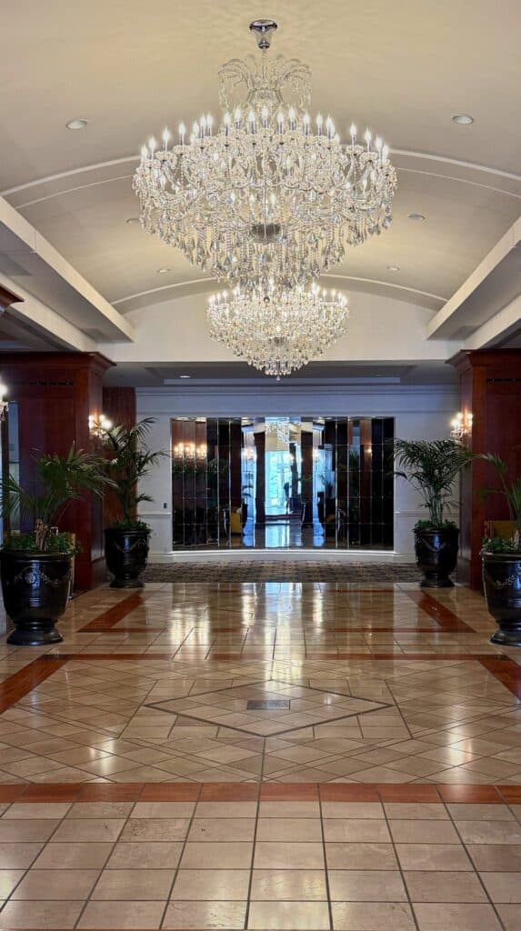 Crystal chandelier and marble entry in the lobby of one of the luxury hotels Colorado Springs is praised for.
