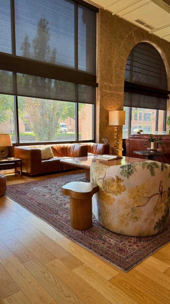 Sunlit lounge with leather sofas and floral armchairs, one of the unusual places to stay Colorado Springs offers.
