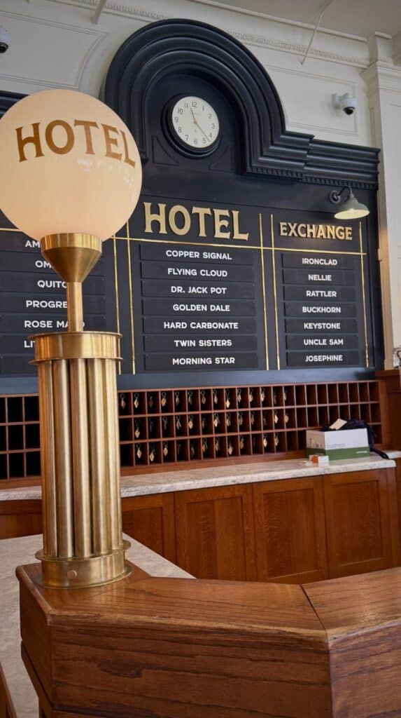 Vintage brass key board listing old mine names at one of the historic hotels Colorado Springs preserves.

