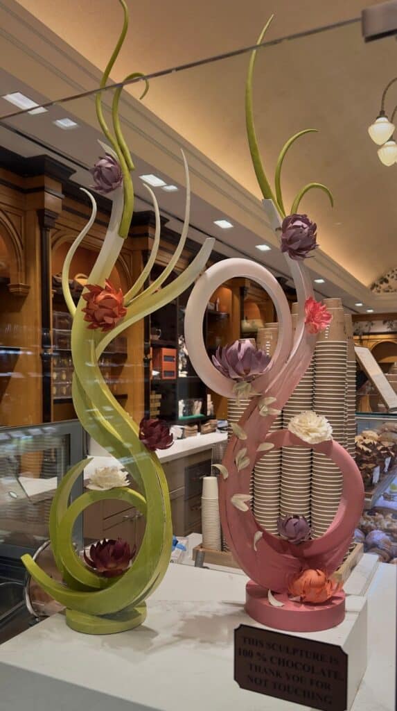 Towering flower-topped chocolate sculptures on the counter at Cafe Julie's