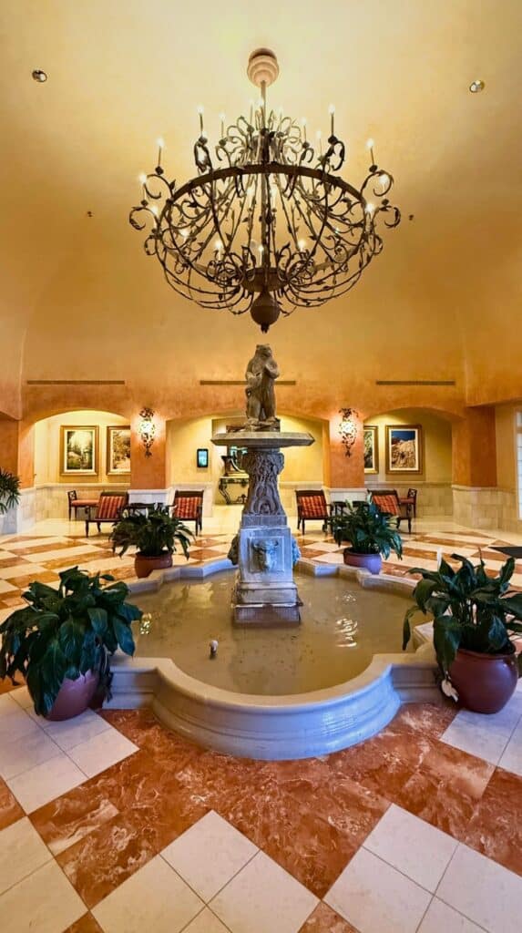 Grand lobby fountain topped by a bronze bear statue inside one of the luxury hotels Colorado Springs is famous for.
