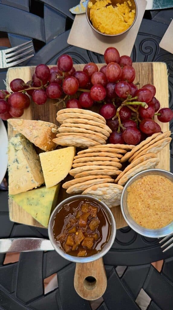 A British cheese board with grapes, crackers, and chutney at the Broadmoor Golden Bee