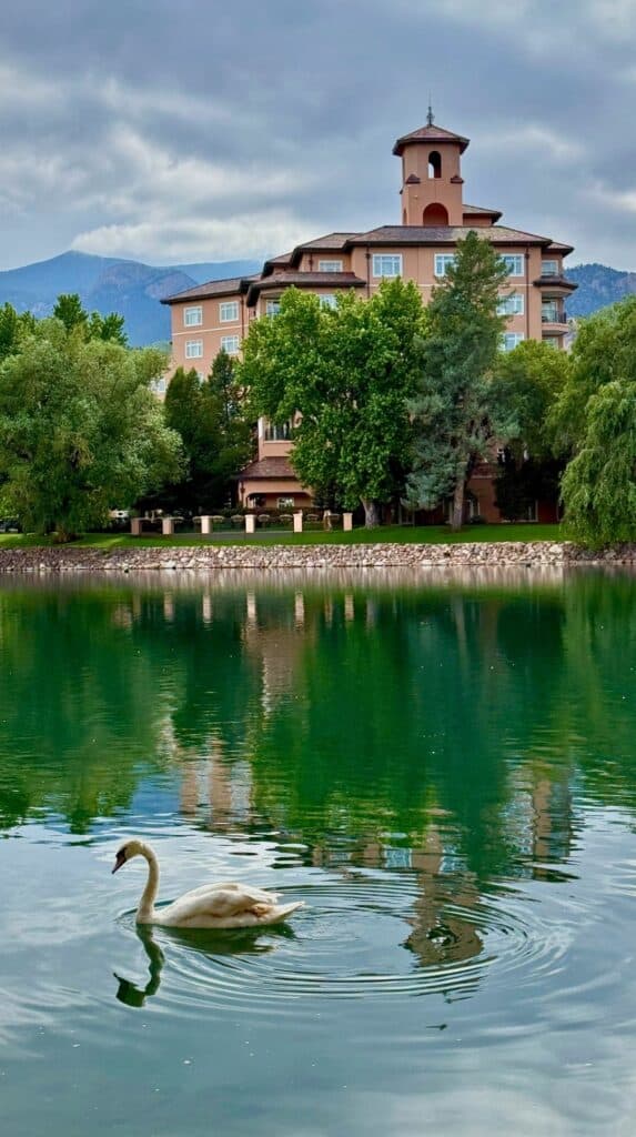 The Broadmoor estate reflected in its lake, one of the historic hotels Colorado Springs visitors treasure.
