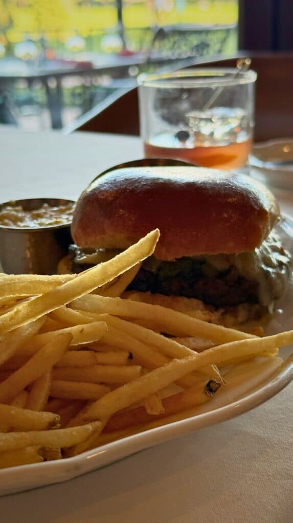 A bison burger with crisp fries and a cocktail at the Grille Broadmoor golf clubhouse
