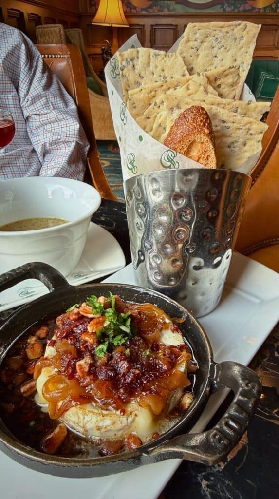 Skillet-baked Camembert under bacon jam and pecans with crackers at the Hotel Bar