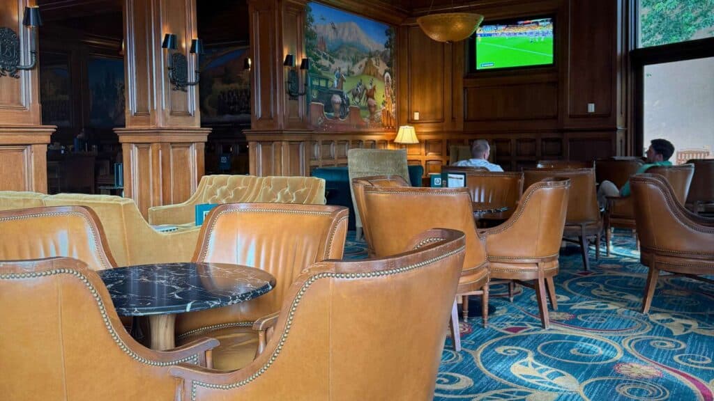 Leather club chairs and marble tables fill a wood-paneled lounge among the broadmoor restaurants and bars